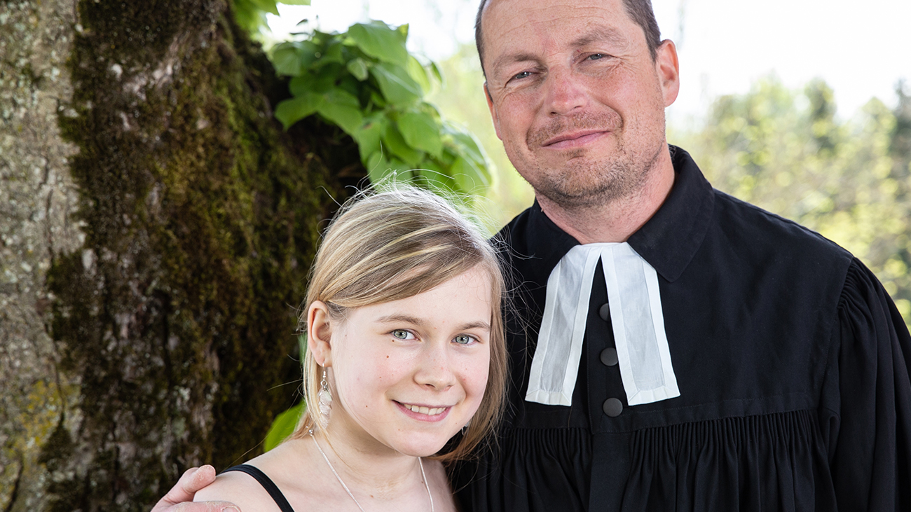 Pastor Ole Dost holds his daughter at her confirmation.